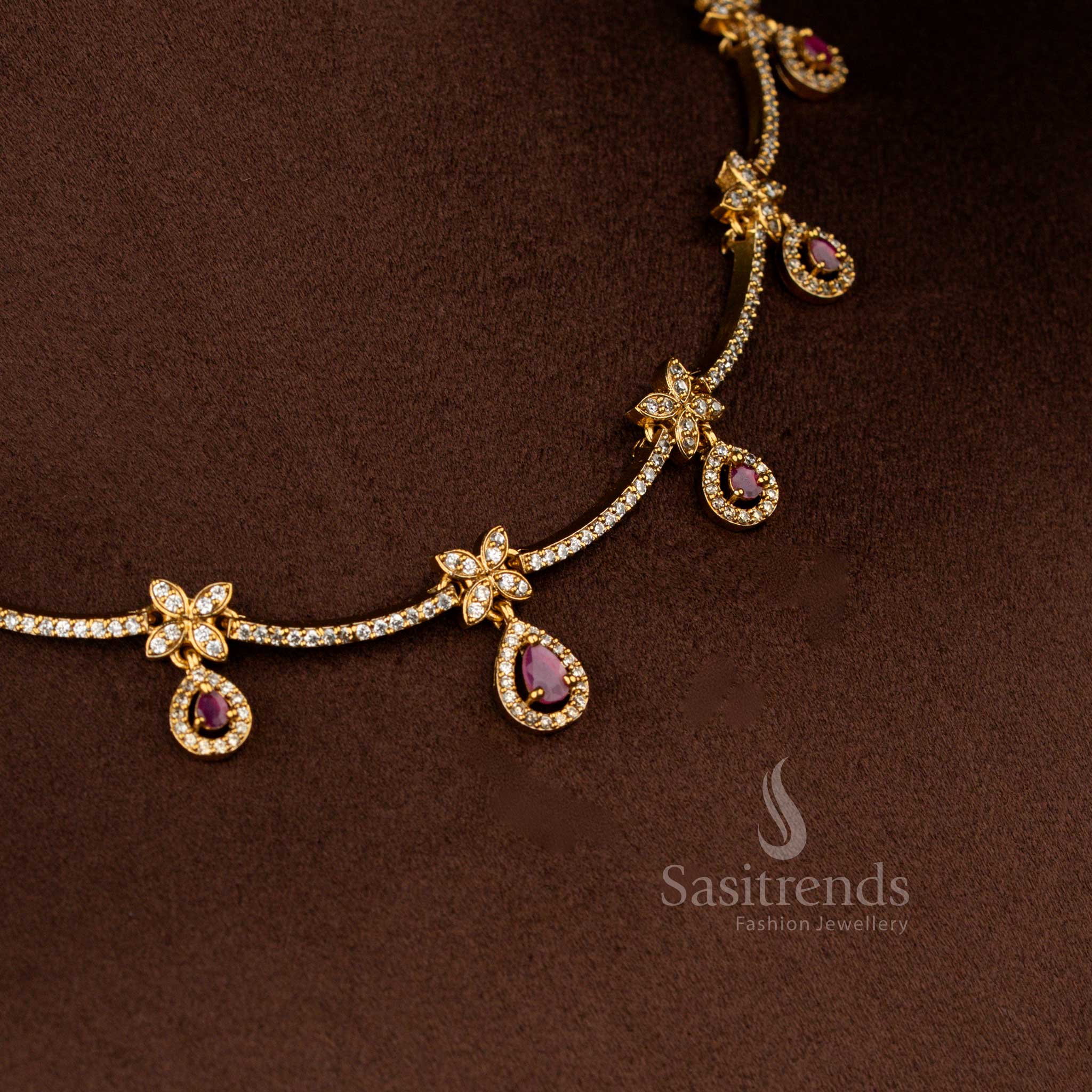 Sasitrends premium white ruby American diamond matte gold floral motif necklace with ruby teardrop stone detailing