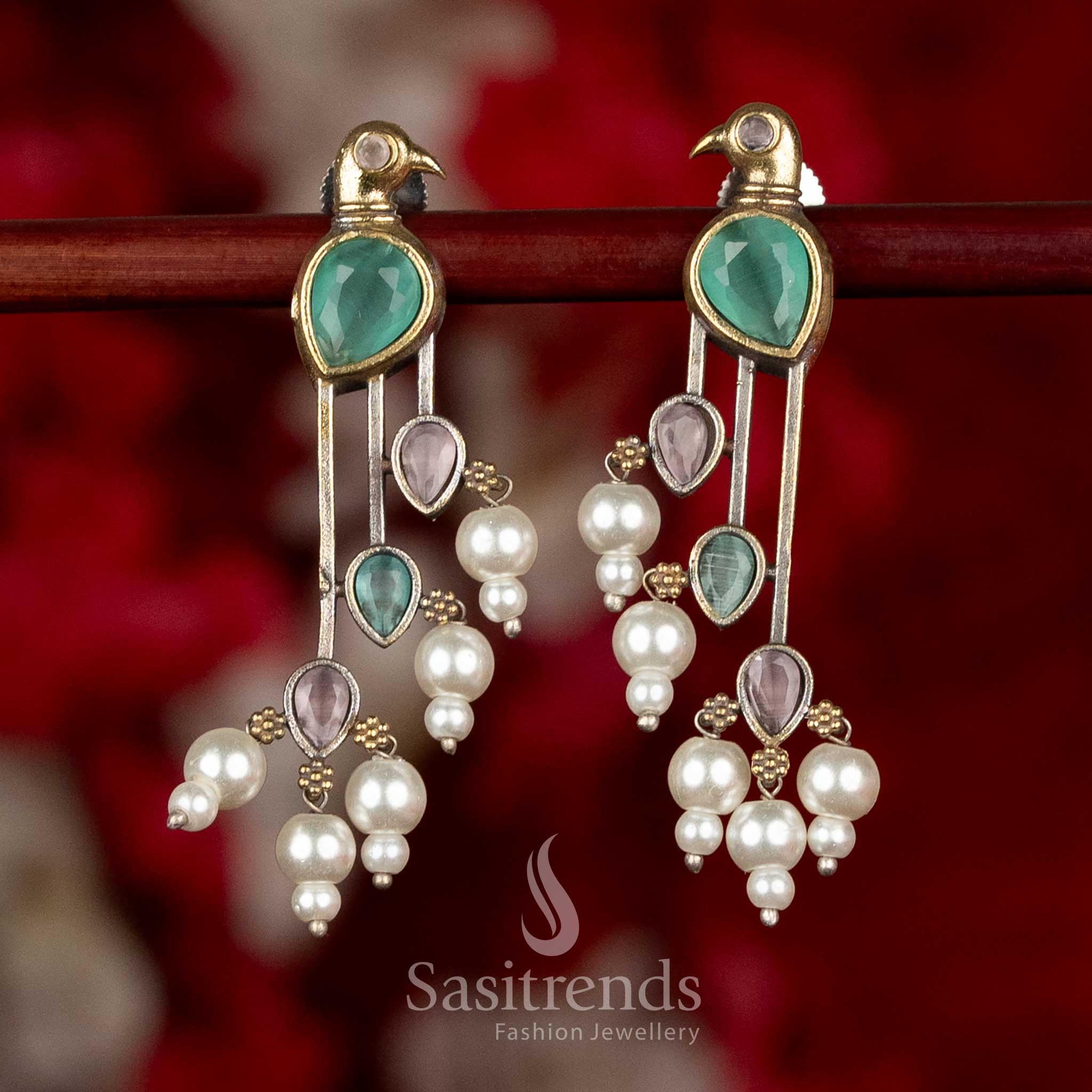 Sasitrends parrot inspired oxidised silver earrings in pink and mint tones crafted with refined stone layout and pearl drop detailing

