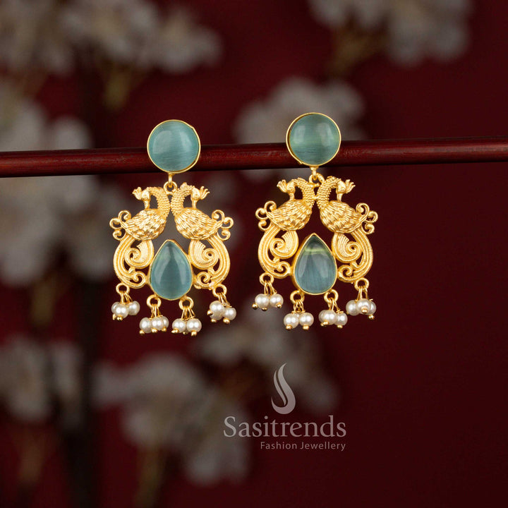 Premium ocean blue 24K gold plated dual peacock earrings from Sasitrends designed with a detailed round frame, luminous teardrop stone centerpiece and pearl embellishments for rich traditional styling.
