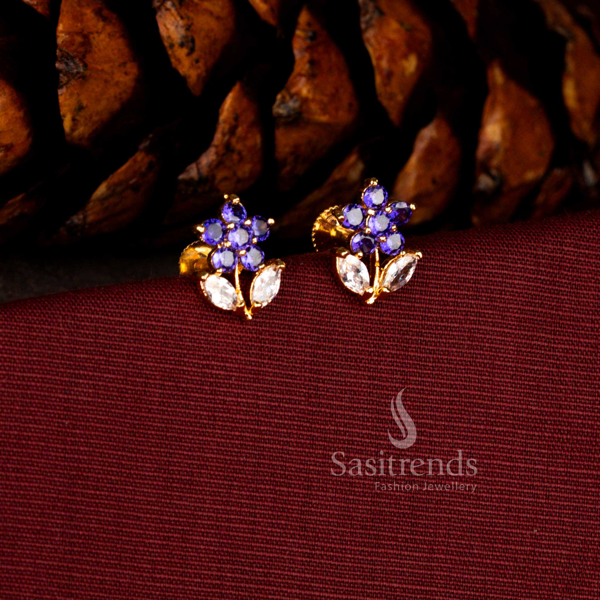 Sasitrends premium one gram micro gold plated earrings crafted in a floral starburst silhouette with sparkling purple AD stones and elegant marquise leaf accents for bridal and celebration wear.