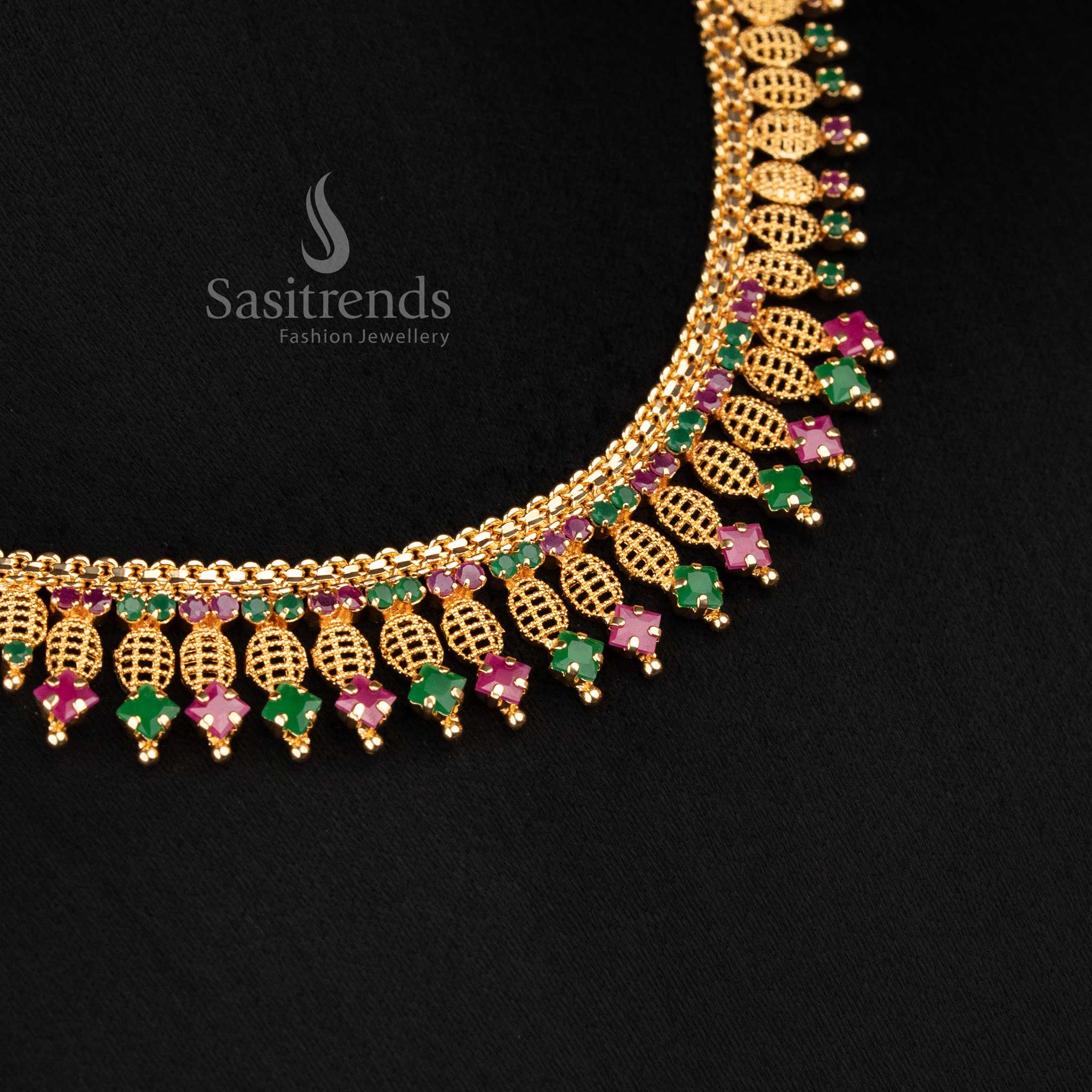 Sasitrends real gold look micro gold plated intricate leaf lattice necklace designed with ruby green AD stone setting and elegant hanging drop pattern in 24K finish