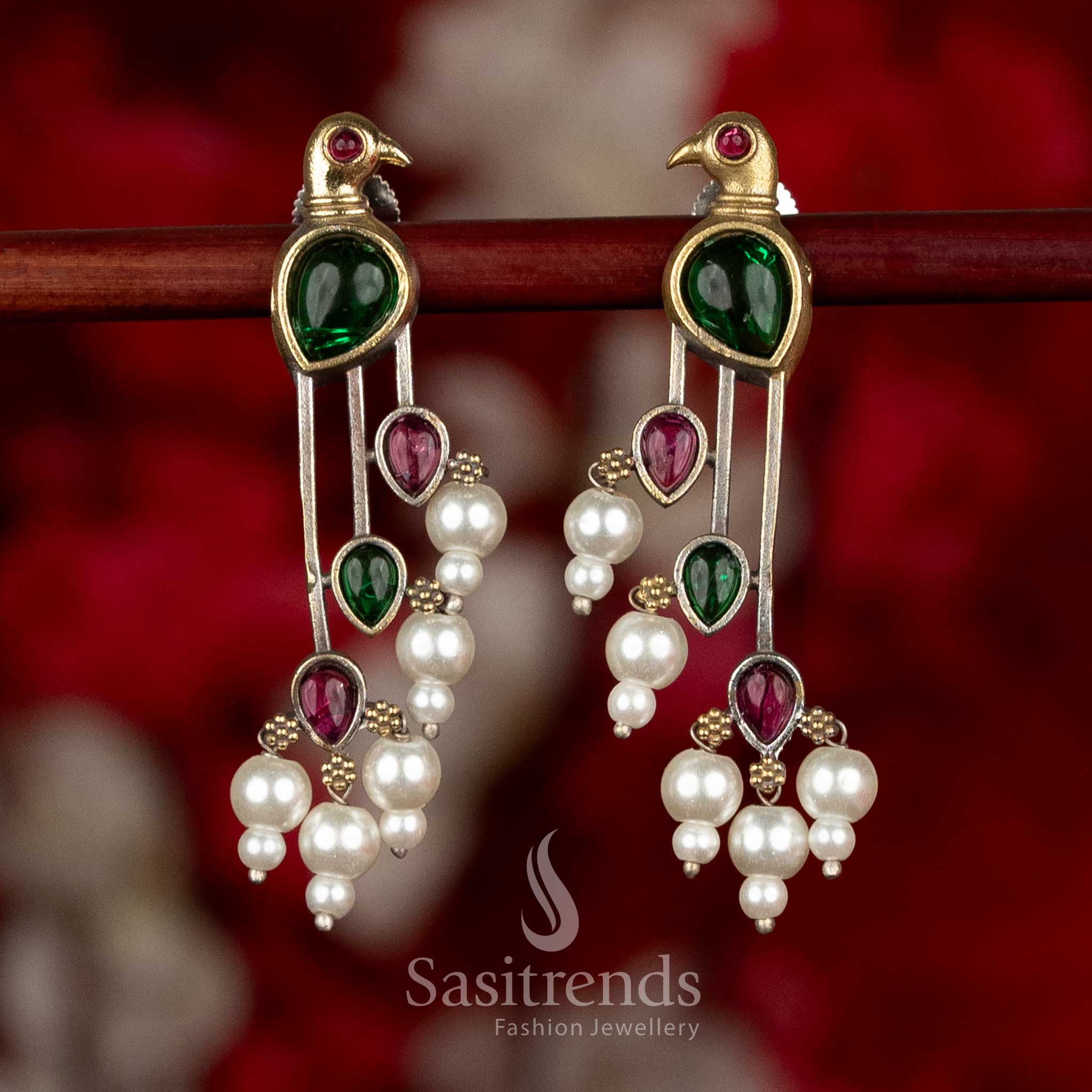 
Sasitrends oxidised silver parrot motif earrings in red and green colour combination featuring balanced long drop design with pearl detailing

