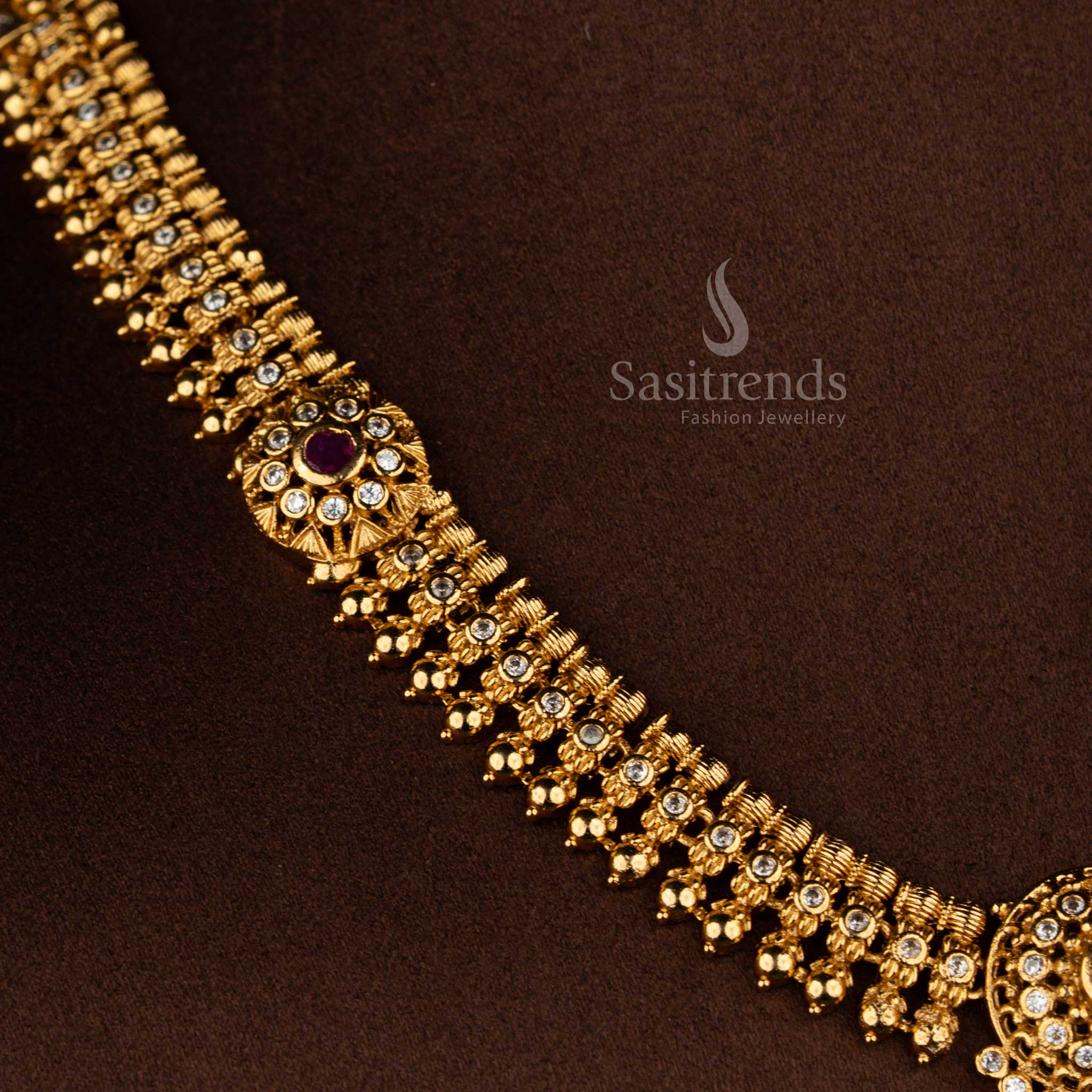 Sasitrends matte gold plated white ruby AD stone temple necklace and earrings with traditional floral design