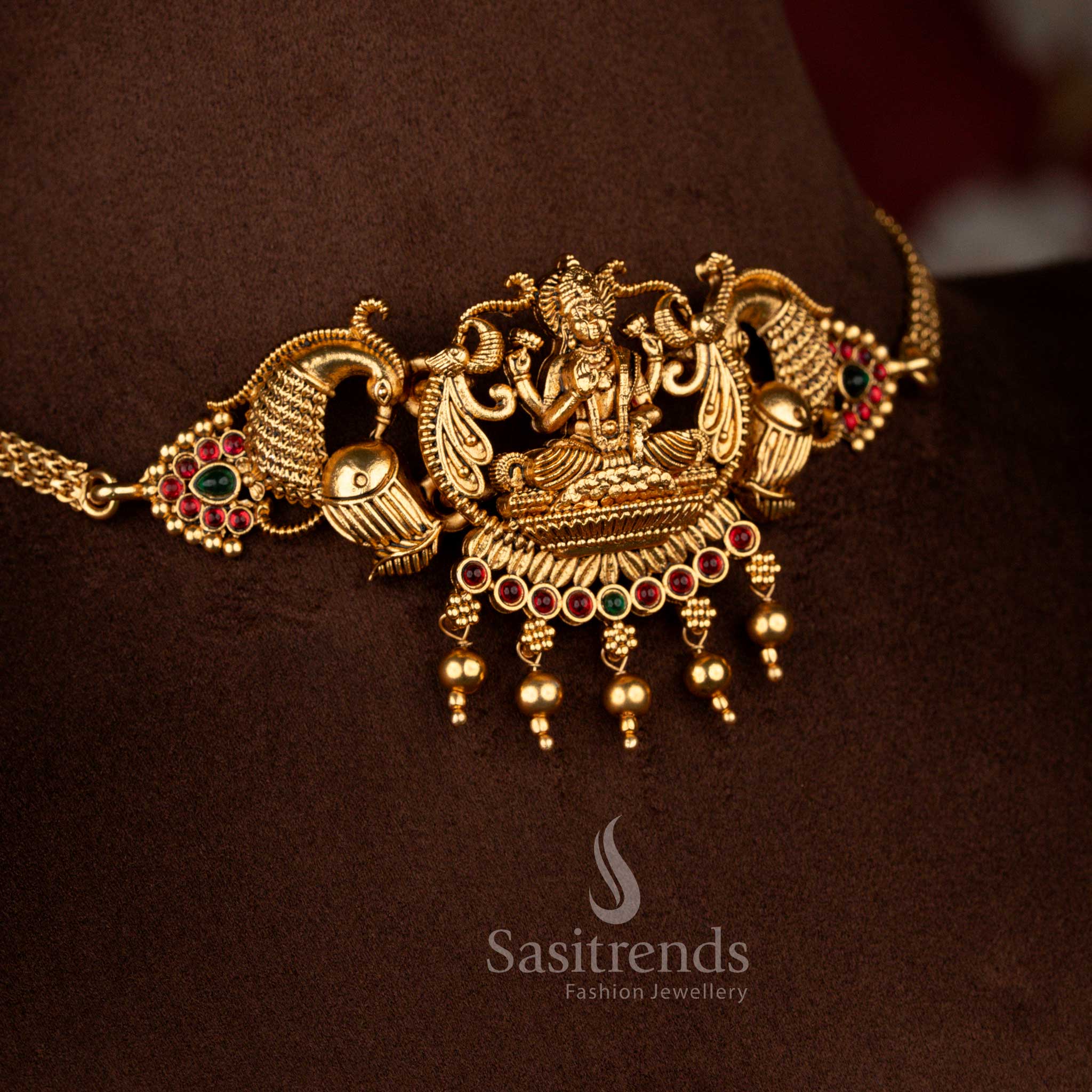 Sasitrends classic ruby green stone matte gold plated peacock Lakshmi idol structured temple choker jewellery set