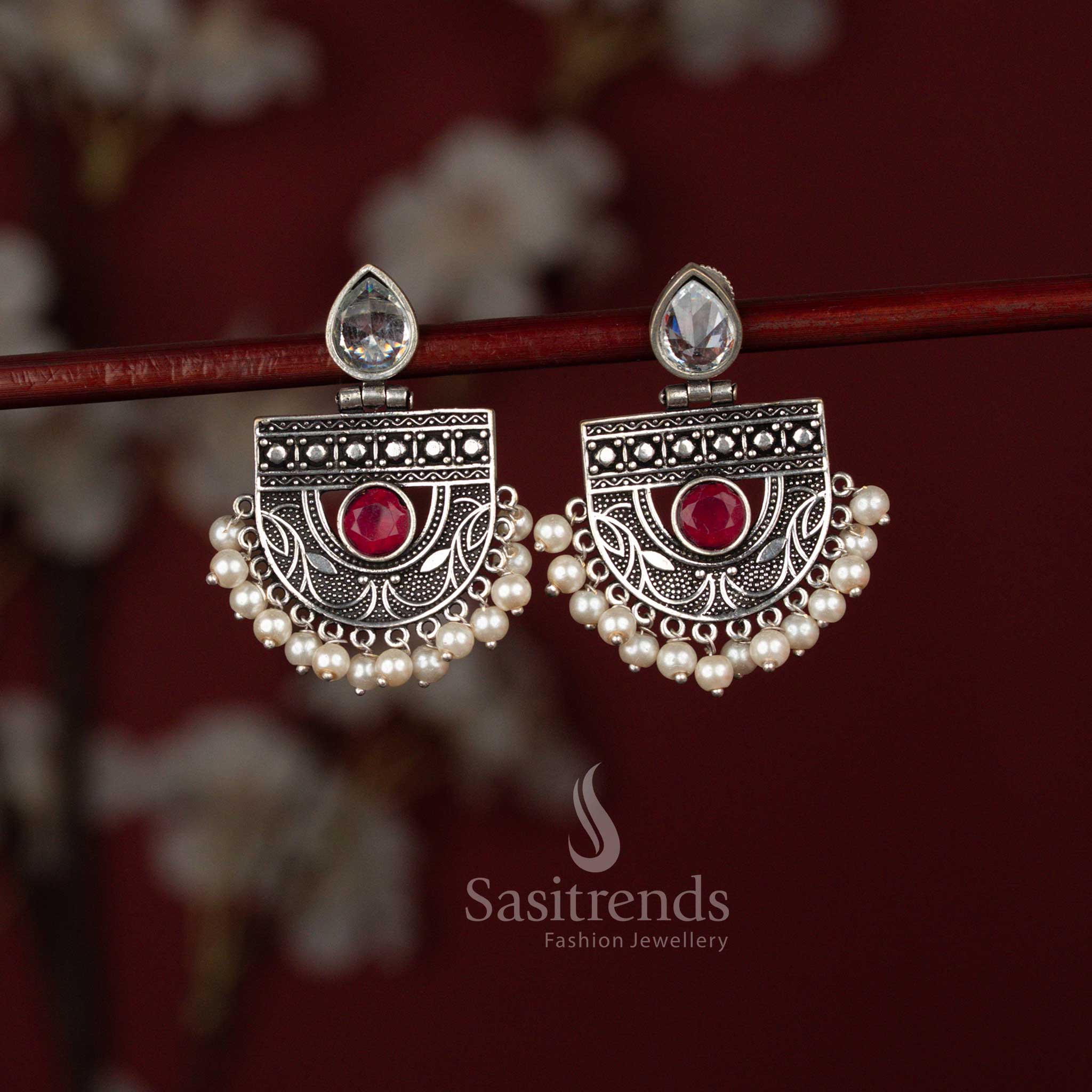 Elegant ruby oxidised silver pear cut stone chandbali earrings from Sasitrends designed with intricate metal craftsmanship, a luminous pear centerpiece and layered pearl hangings for traditional and celebration wear.
