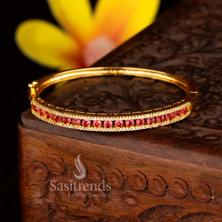 Sasitrends stylish micro gold plated two rows of petite white red American diamond openable kada bracelet crafted with polished gold tone and shimmering stones.