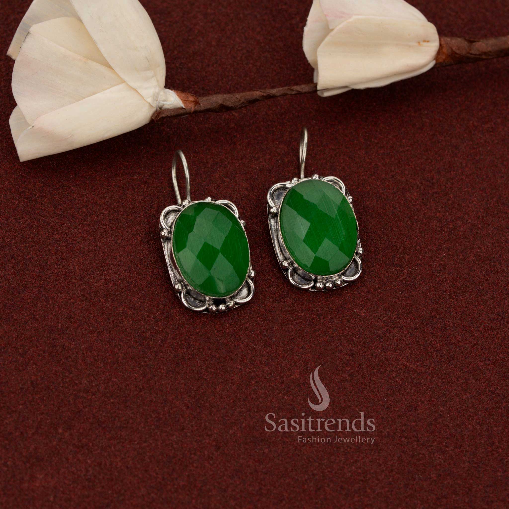 Sasitrends stylish oxidised German silver earrings featuring faceted oval green stone with decorative floral frame design