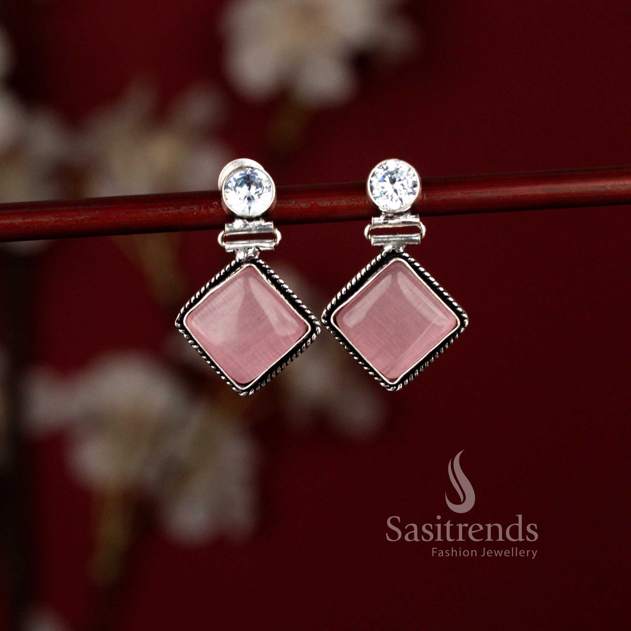 Stylish pink oxidised drop earrings by Sasitrends showcasing a geometric rhombus silhouette highlighted with a luminous Monalisa stone, suitable for daily office wear, light festive dressing and casual gatherings.