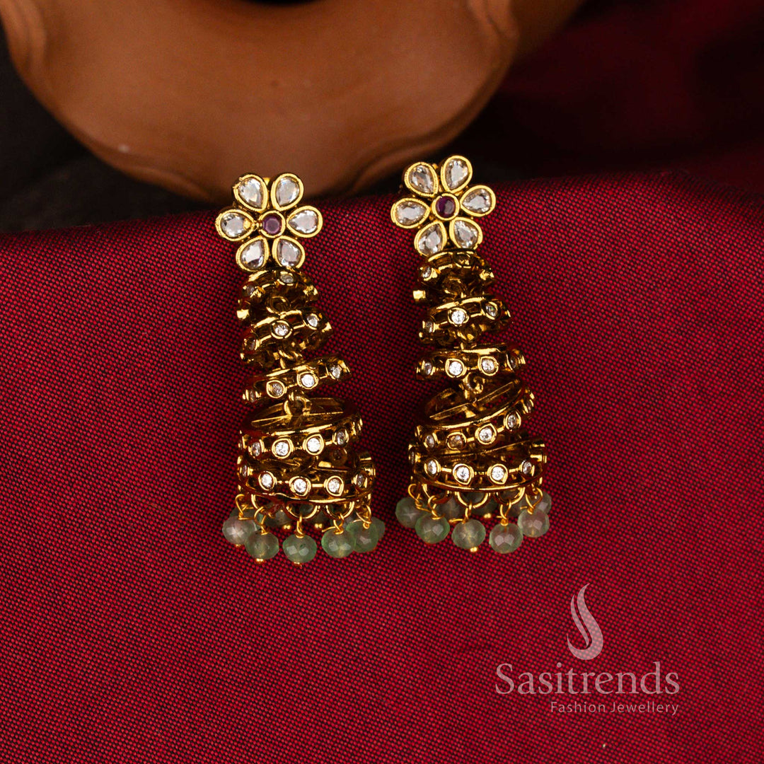 Sasitrends temple matte gold plated American Diamond five step layered jhumka earrings with floral stud top