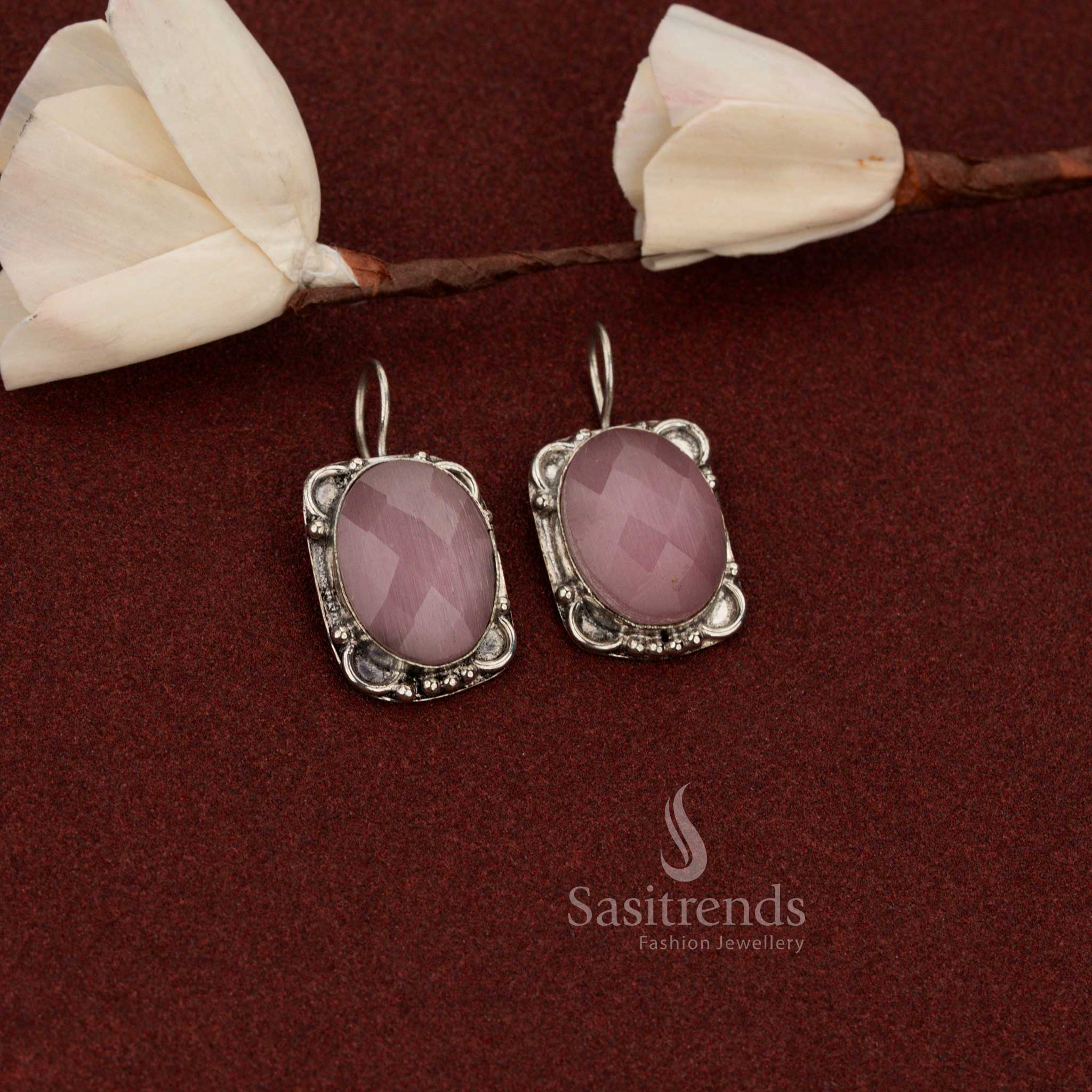 Sasitrends traditional look oxidised German silver earrings crafted with oval faceted pink stone and floral frame accents