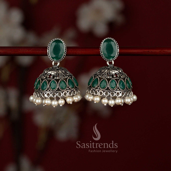 Traditional green oxidised German silver jhumka earrings from Sasitrends featuring a Monalisa oval stud top, ornate elephant motif design, teardrop stone highlights and elegant pearl drops perfect for festive sarees and celebration wear.