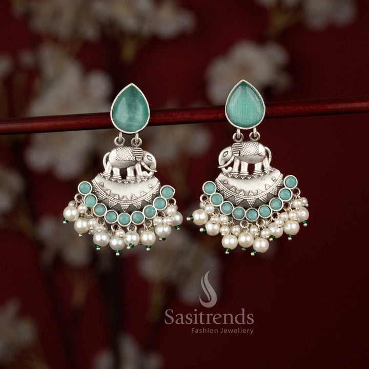 Traditional mint oxidised silver elephant crescent earrings from Sasitrends crafted with intricate metal detailing, luminous teardrop stone accents and layered pearl drops that enhance festive attire and cultural celebration wear.