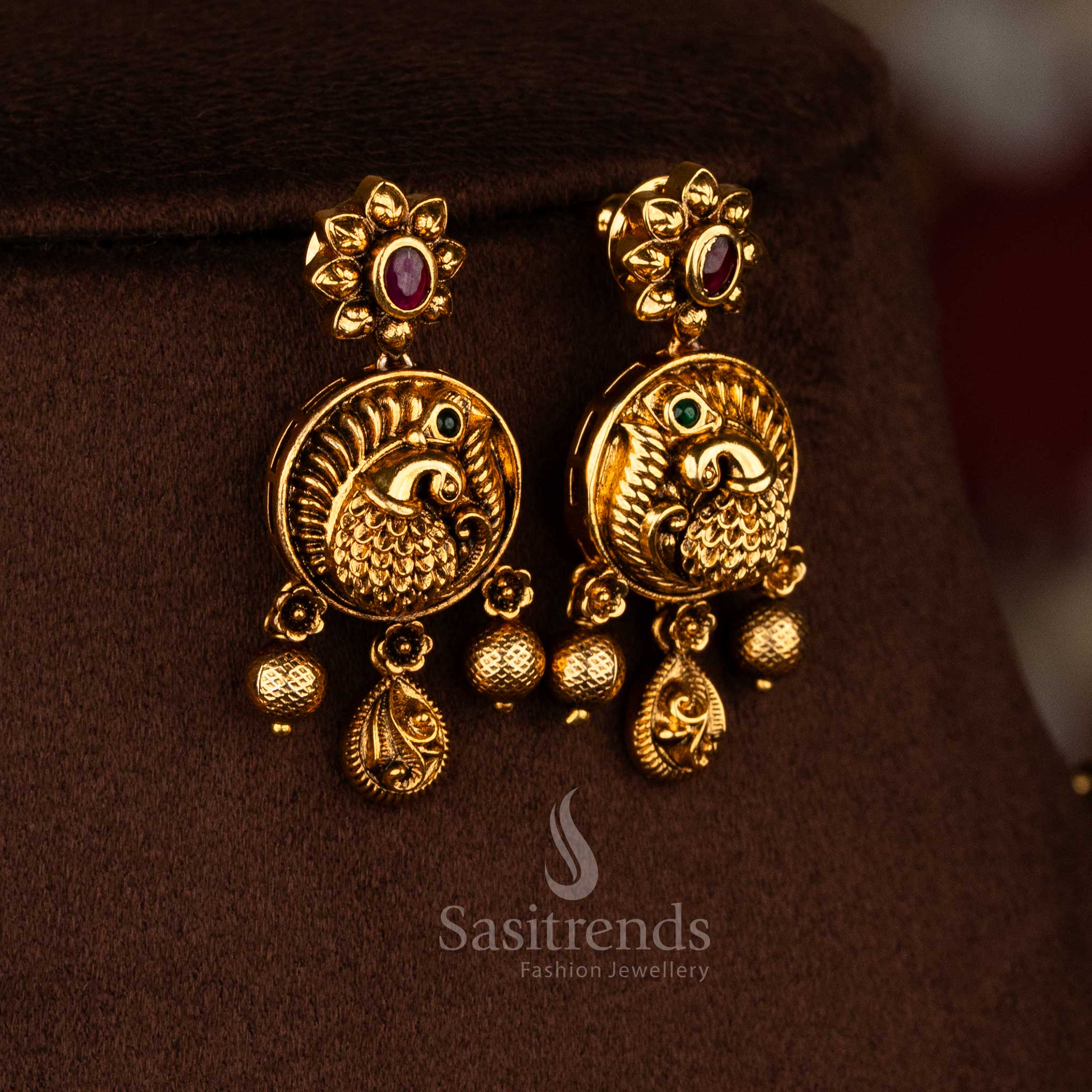 Sasitrends festive temple wear double layer ruby green AD stone matte gold plated necklace set with elegant peacock inspired detailing