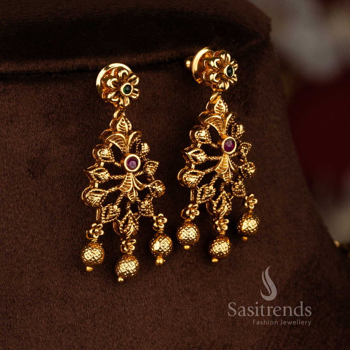 Sasitrends traditional saree wear temple necklace set featuring matte gold finish, ruby green AD stones, carved leaf design, and rich bead hangings