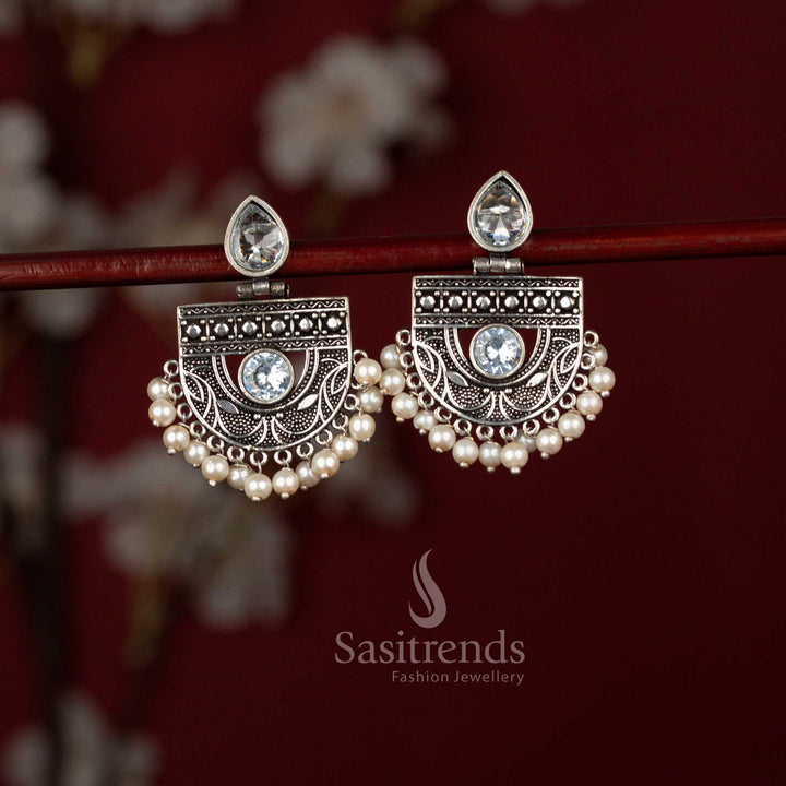 Traditional white oxidised silver chandbali dangler earrings by Sasitrends showcasing a pear-shaped stone focal point, ornate crescent detailing and refined pearl accents perfect for kurtis and festive functions.
