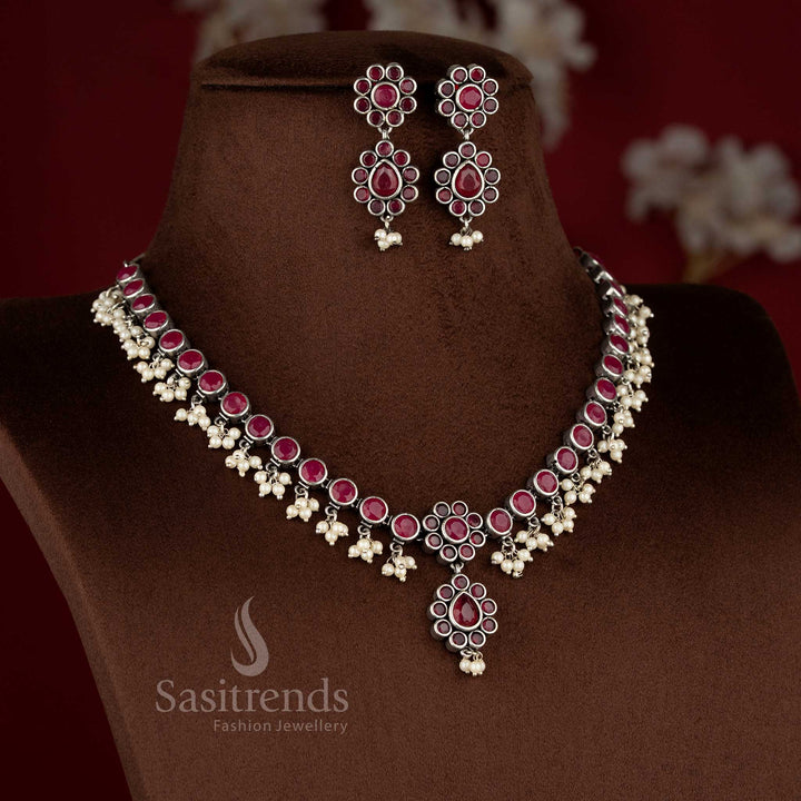 Oxidised floral pearl drop ruby stone necklace set featuring structured traditional motifs and matching earrings - Sasitrends