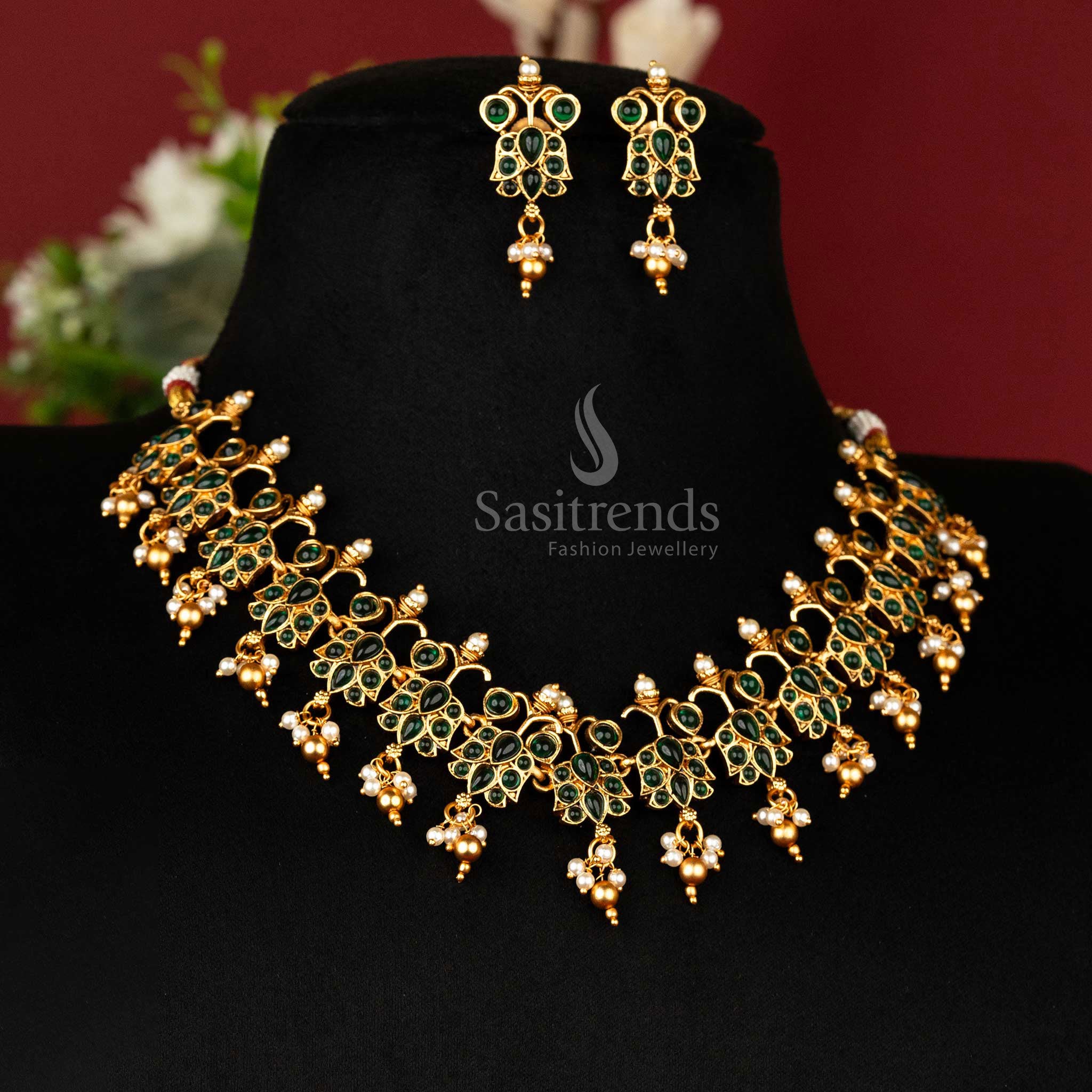 Elegant green-studded temple necklace set in classic matte gold, styled with ethnic earrings – timeless jewellery for special moments – sasitrends