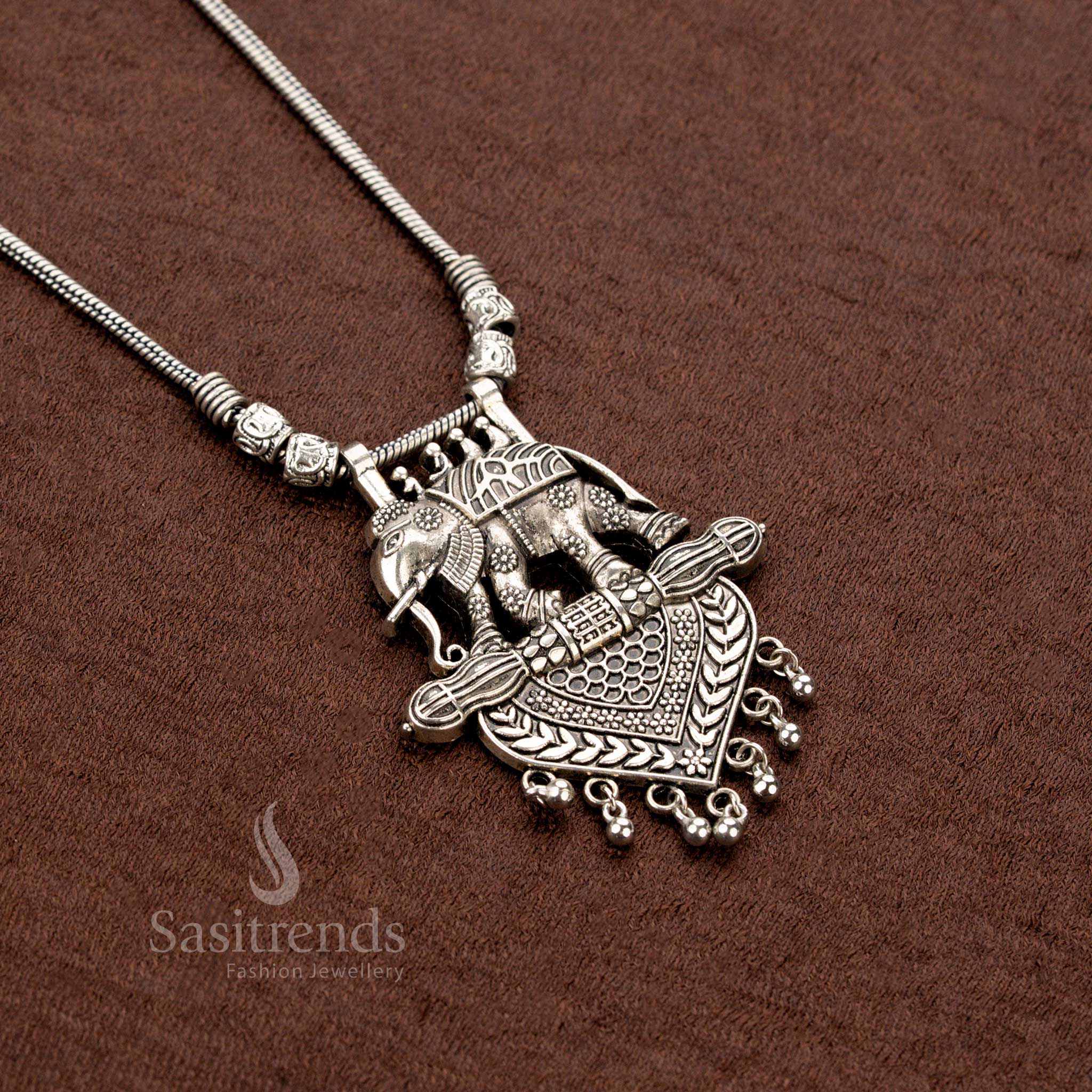 Oxidised tribal necklace featuring double elephant motifs with heart-shaped engraved pendant and antique ball hangings – Sasitrends