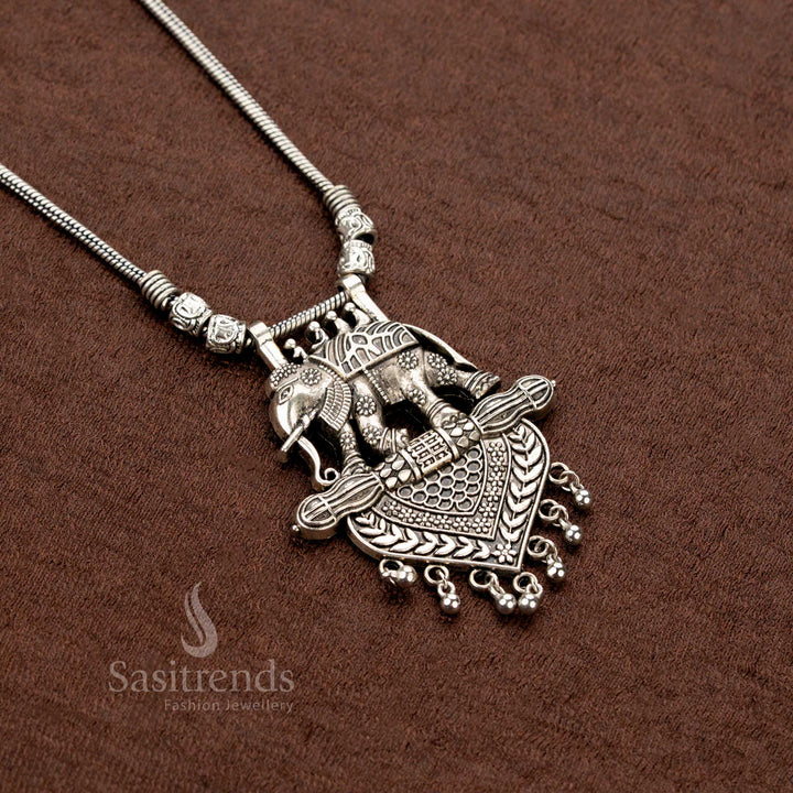 Oxidised tribal necklace featuring double elephant motifs with heart-shaped engraved pendant and antique ball hangings – Sasitrends