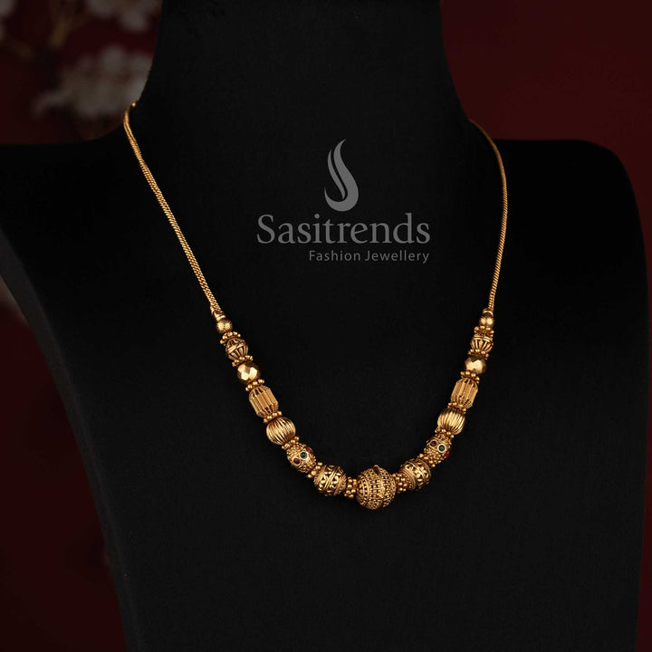Elegant Sasitrends matte gold temple jewellery necklace with textured spherical bead arrangement, ornate cylindrical elements and distinctive central ball detail