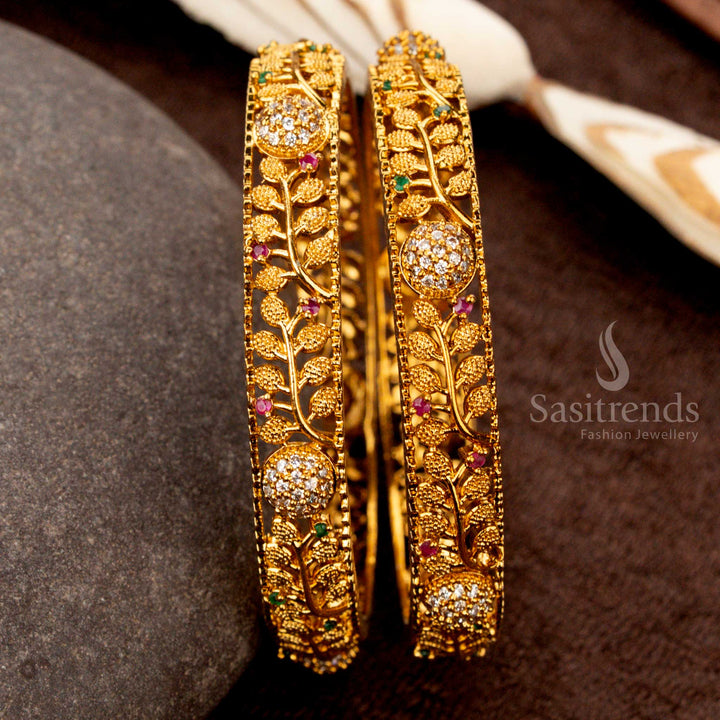 Festive matte gold bangles adorned with multi-hued AD stones and intricate leaf motifs, perfect for ethnic and wedding attire - Sasitrends