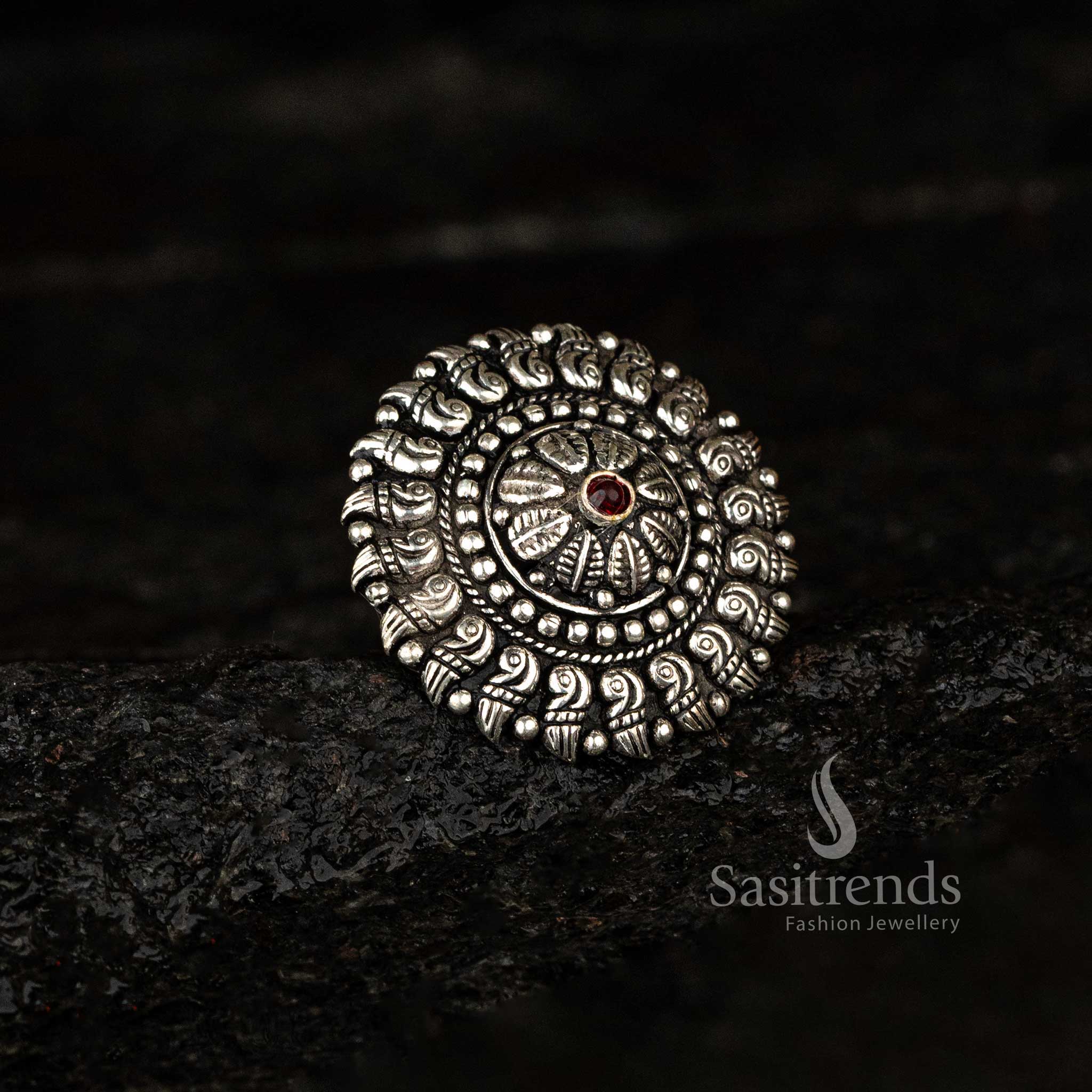 Traditional oxidised ring featuring paisley designs and a round red stone - Sasitrends