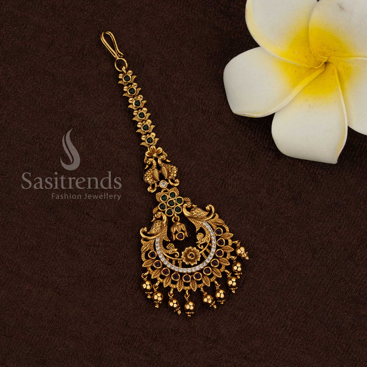 Temple matte gold plated peacock motif maang tikka with multi kemp AD stone detailing and hanging bead drops, rich premium look ideal for bridal, wedding, and temple wear - Sasitrends
