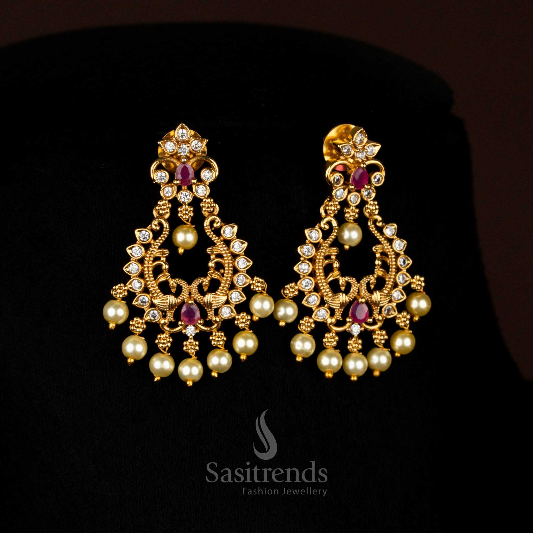 Opulent white-Ruby Matte Gold Plated Temple Drop Earrings with Artistic Filigree Design and Brilliant AD Stones, Ideal for Festive Celebrations – Sasitrends