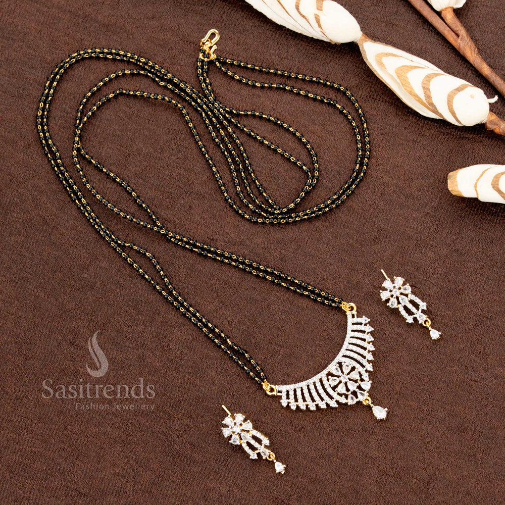 Dazzling white AD pendant set with an intricate floral pattern, paired with a micro gold plated Mangalsutra chain and earrings, a premium jewellery piece for special occasions - Sasitrends