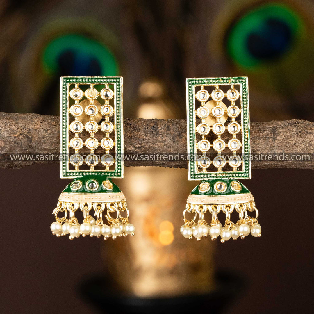 Green gold-plated Kundan studded jhumka earrings with pearl details for a sophisticated look